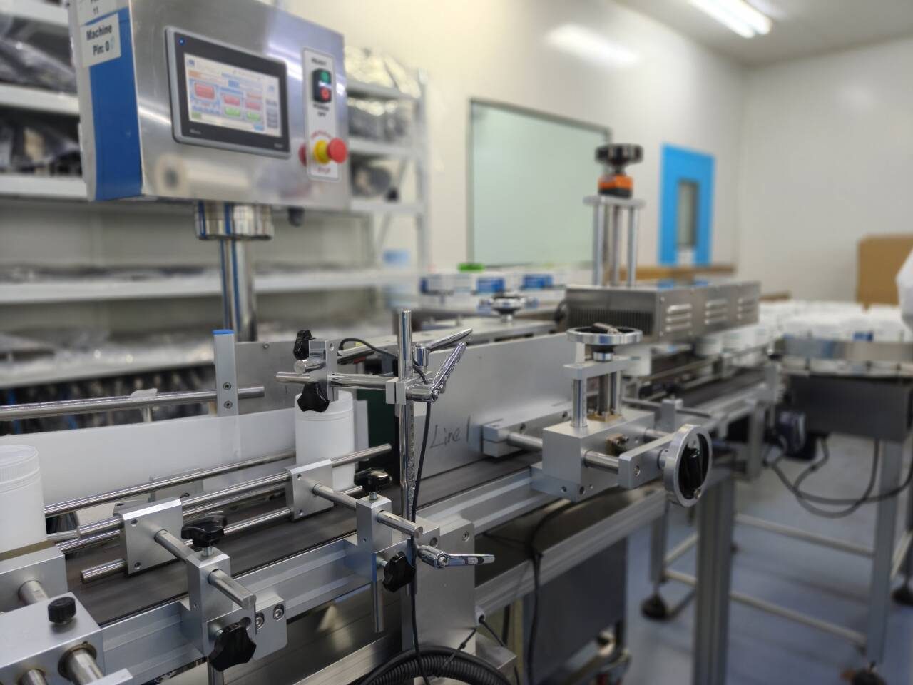 Control panel and conveyor on a bottle filling line